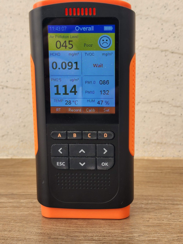 Air quality monitor showing PM2.5 at 114, rated poor