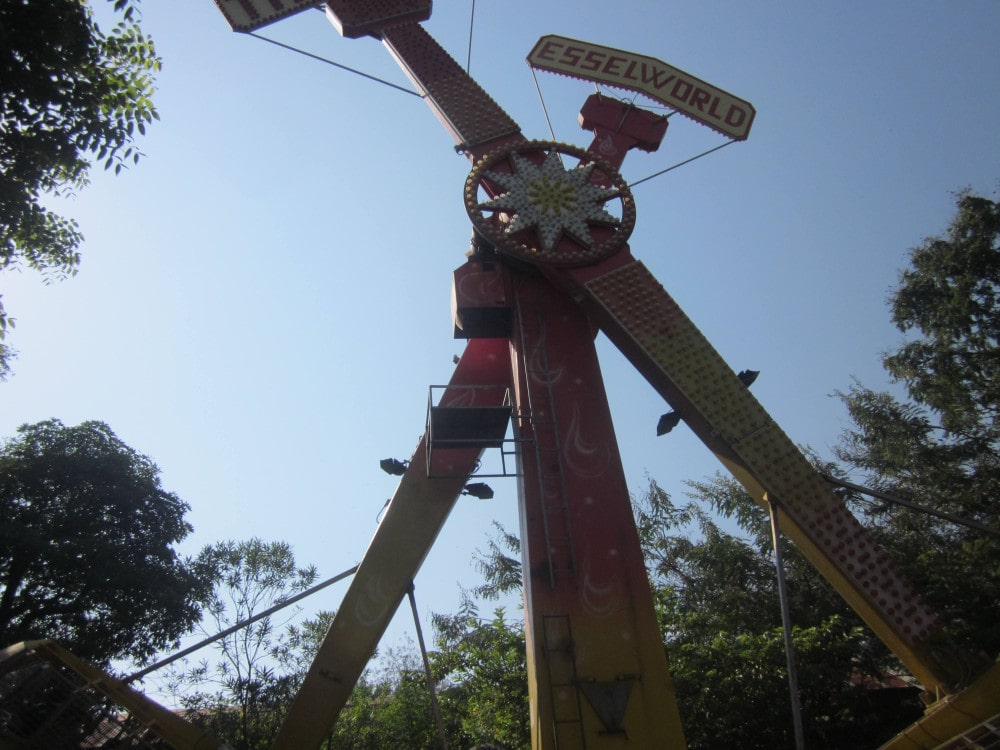 Swinging pendulum ride at an amusement park against the sky